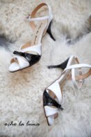 Black and white tango dance shoes with a bow